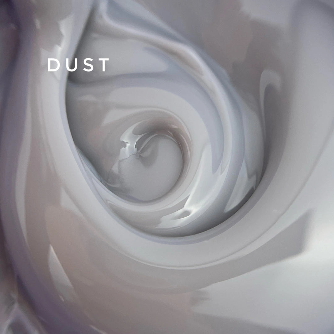 Close-up of swirling white liquid with 'DUST' text overlay