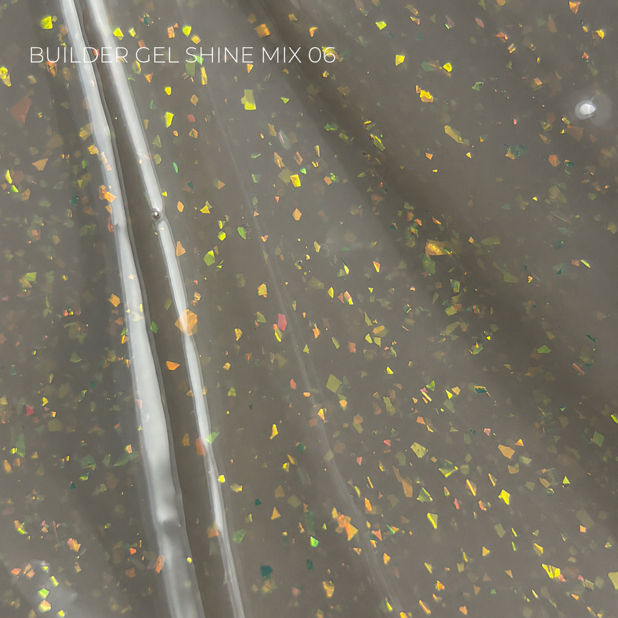A close-up of a translucent gray gel sheet with embedded holographic glitter flakes, showing rainbow reflections. White text in the top left reads 'BUILDER GEL SHINE MIX 06'.