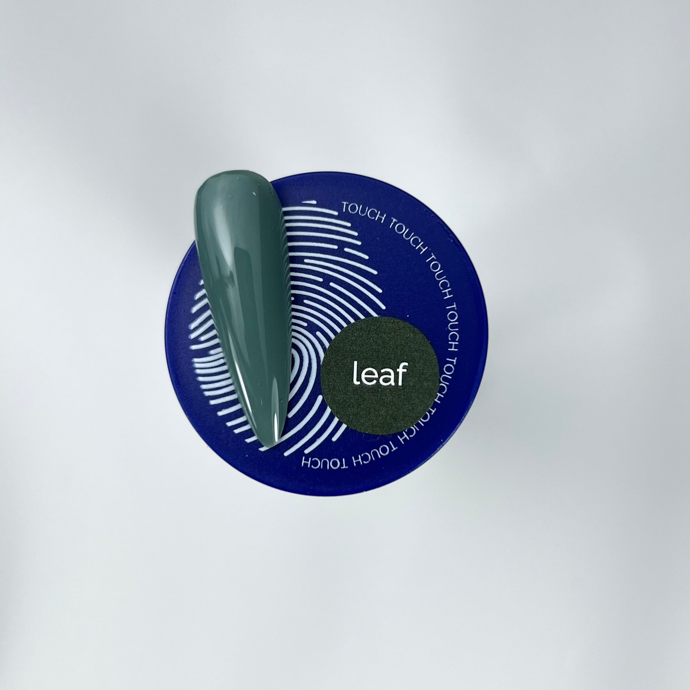 green colour nail swatch and blue jar