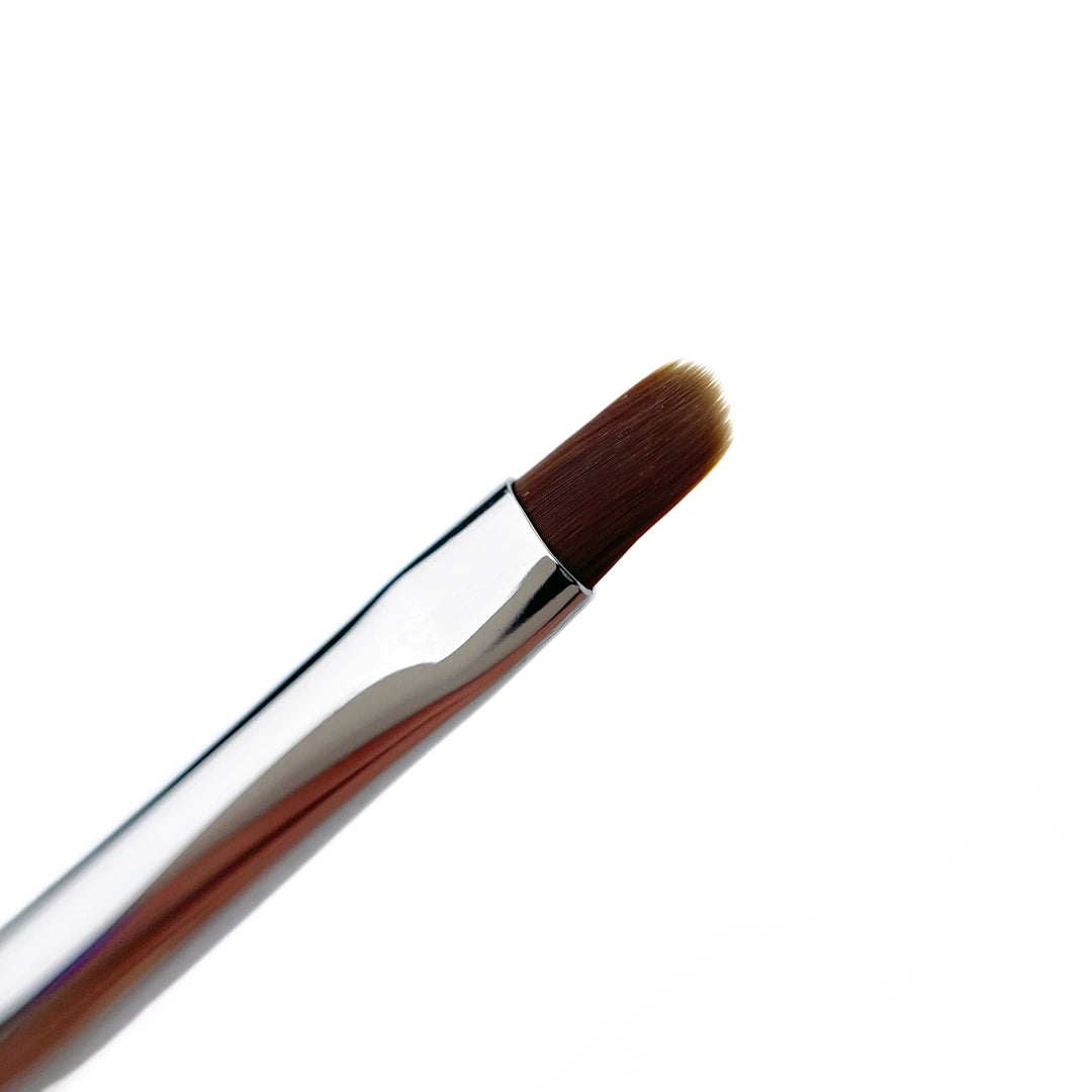 Makeup brush with brown bristles on a white background